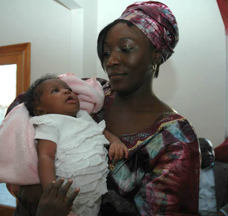 One month old Sira Saccoh at her baby shower with a woman who is not her mother.