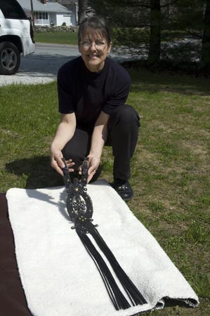 Ava showing one of her braided leather sallangs which adorn the back of the horse