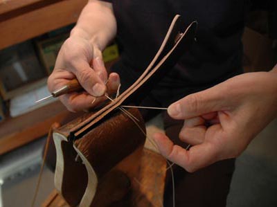 Ava sewing using an awl and two needles