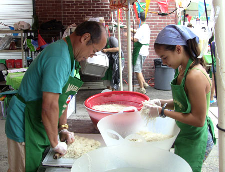Emilio Liwanag and Carsyn Fisher chopping noodles.