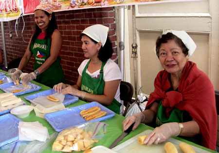 Maria Brion, Imelda Alanguilan, and Chris Castro roll banana turon.