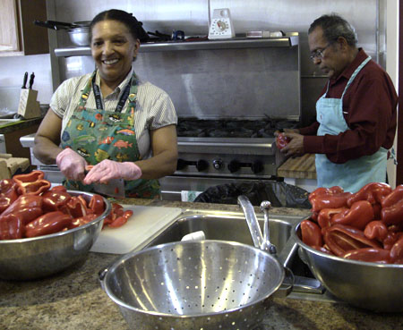 Edith and Nalin Parekh chopping red peppers for curry sauce.