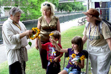 Jonas Stundzia makes a head garland for visitors.