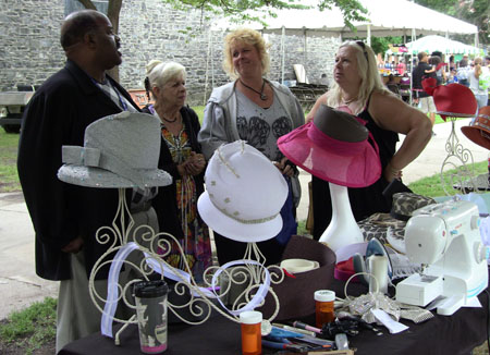 Samuel Brown tells visitors about his hats.