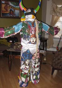 Leonardo Mirabal dressed in fancy suit with lechone mask backview