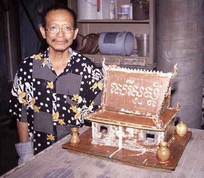 Yary Livan with spirit house. Photo by Kathy Neustadt
