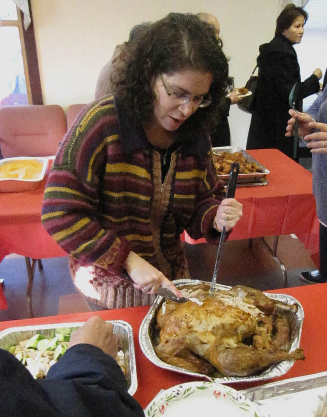 Emily Weitzman Rosenbaum, Executive Director of the CBA, carving a 22-pound turkey